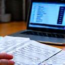 Financial reports and invoices being printed