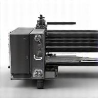 A complex fuser assembly with heating elements and rollers, appearing sturdy and critical.